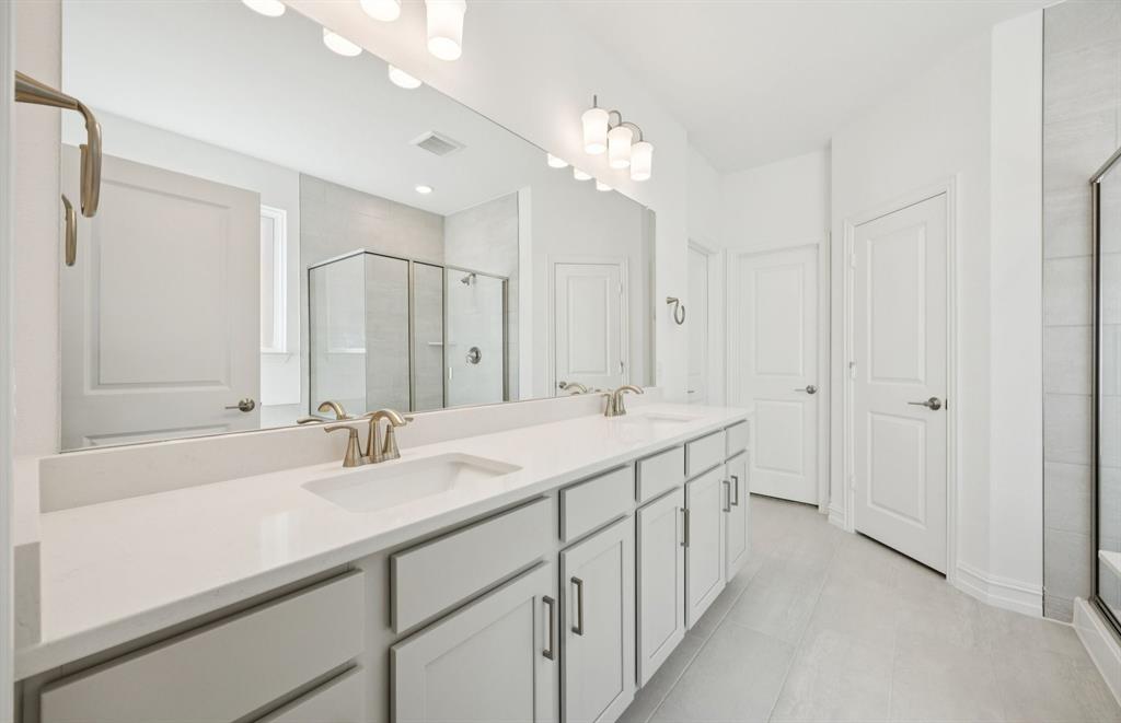 3048 Cliffside Drive Celina, TX 75009 - Photo 8 of 14 a bathroom with a double vanity sink mirror and