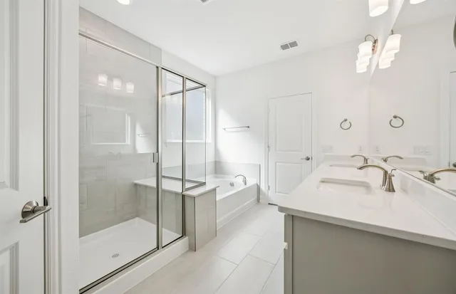 a bathroom with a shower sink and mirror