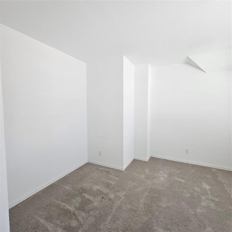 2309 Jack Rabbit Way Northlake, TX 76247 - Photo 19 of 28 Carpeted interior room featuring neutral white walls and white baseboards