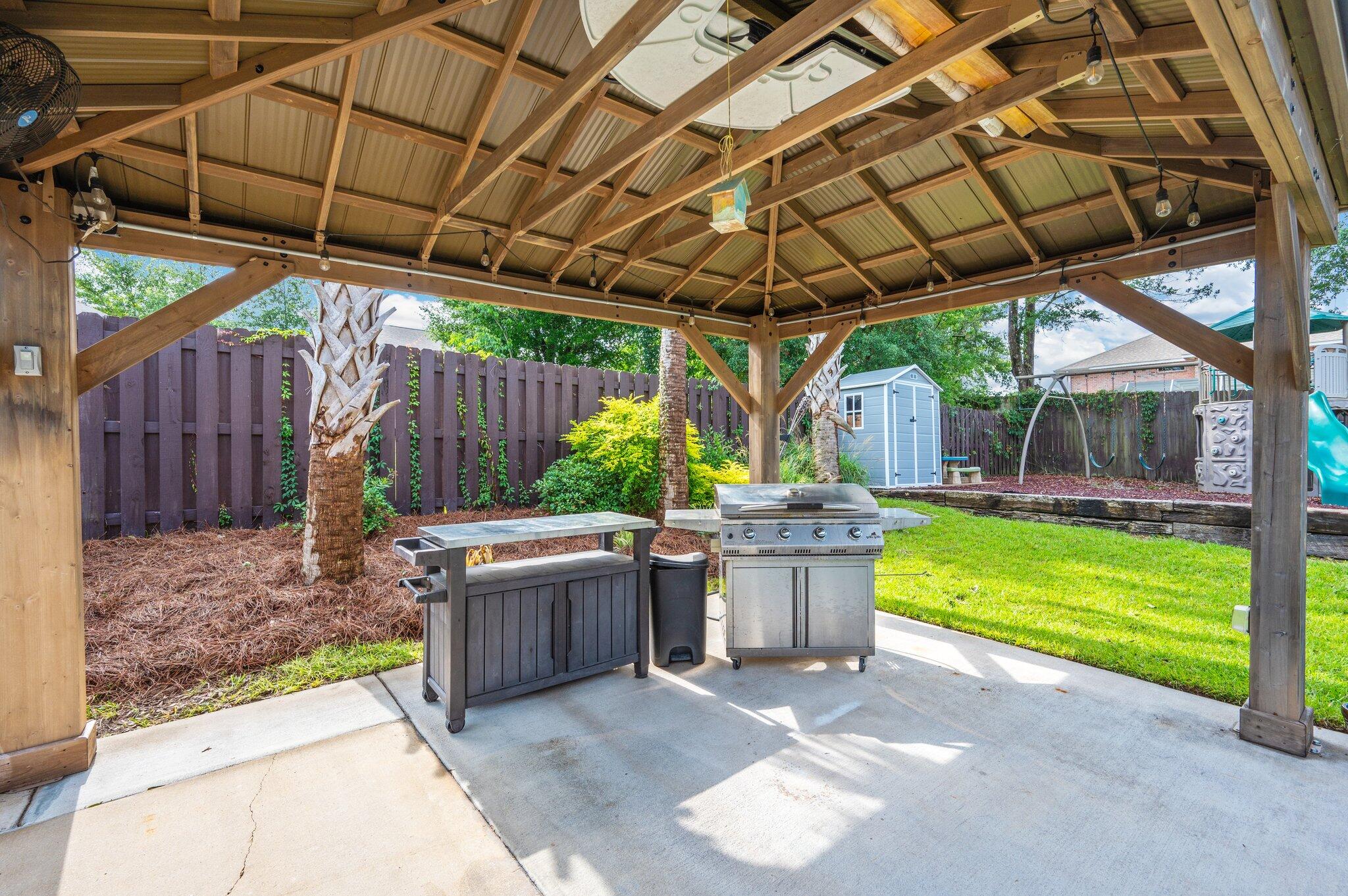 305 Vale Loop Crestview, FL 32536 - Photo 54 of 61 a view of a backyard with plants and a patio