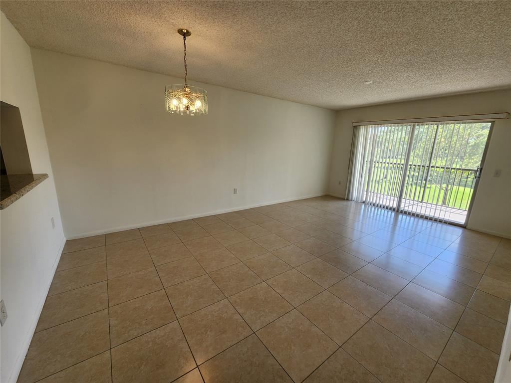 1650 Southwest 124th Terrace, Unit 209D Pembroke Pines, FL 33027 - Photo 16 of 19 a view of an empty room with glass door