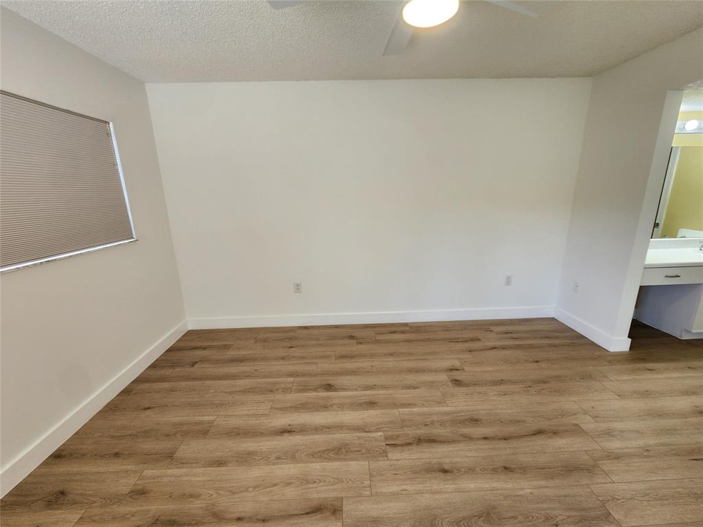 1650 Southwest 124th Terrace, Unit 209D Pembroke Pines, FL 33027 - Photo 18 of 19 a view of empty room with wooden floor