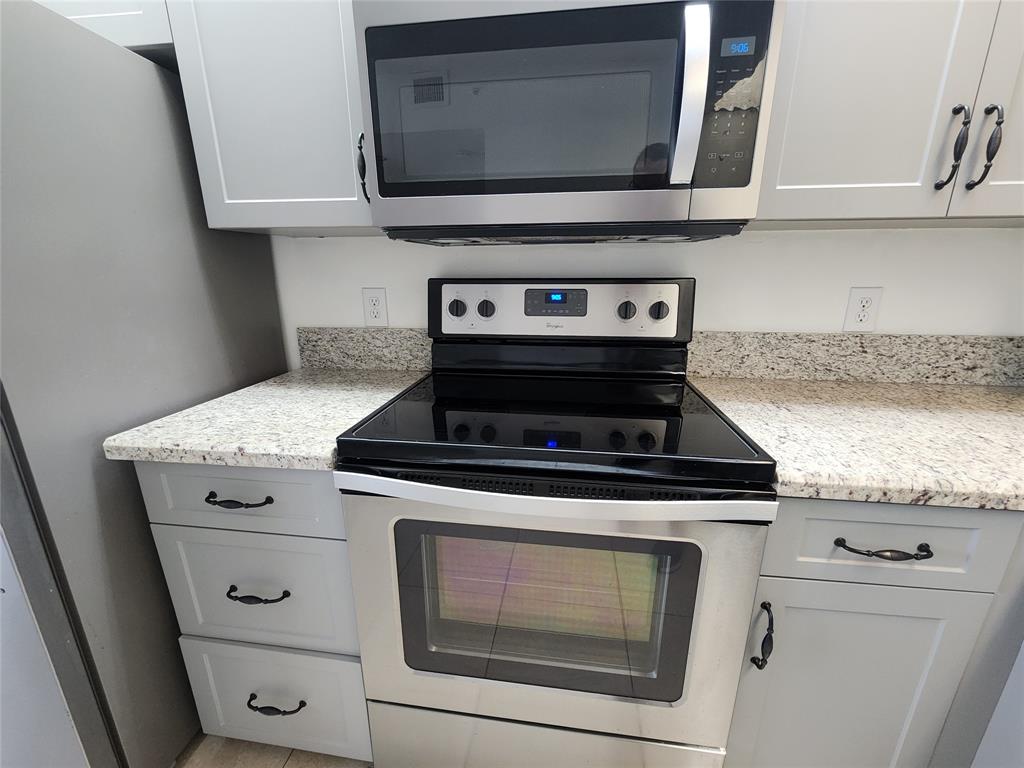 1650 Southwest 124th Terrace, Unit 209D Pembroke Pines, FL 33027 - Photo 5 of 19 a stove top oven sitting inside of a kitchen