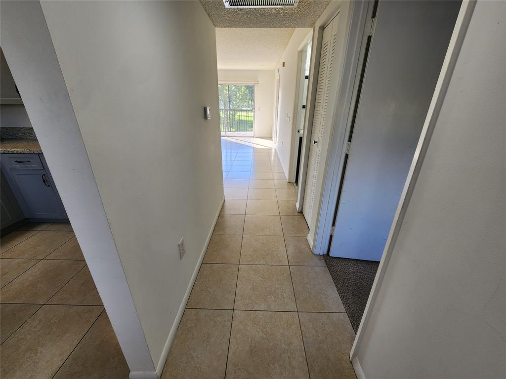 1650 Southwest 124th Terrace, Unit 209D Pembroke Pines, FL 33027 - Photo 9 of 19 a view of a hallway and wooden floor