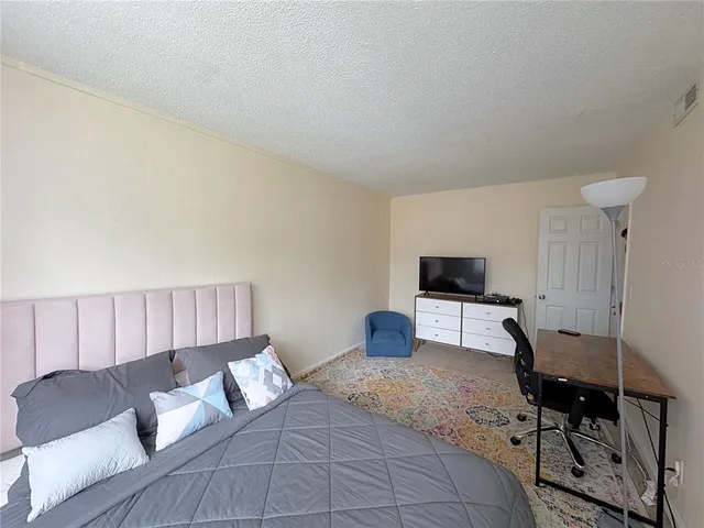 a bedroom with a bed and a television