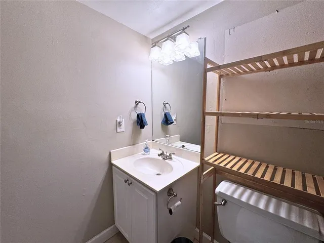 a bathroom with a sink mirror and a shower
