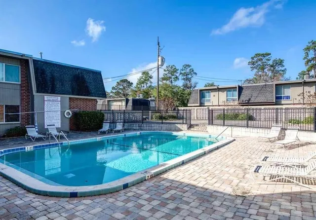a view of a swimming pool with a patio