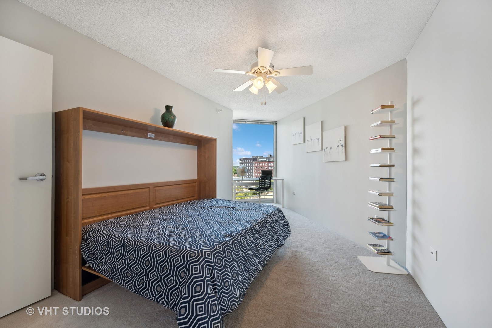 1720 Maple Avenue, Unit 1040 Evanston, IL 60201 - Photo 15 of 35 a bedroom with a bed and a chandelier