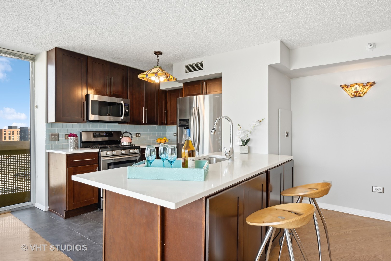 1720 Maple Avenue, Unit 1040 Evanston, IL 60201 - Photo 4 of 35 a kitchen with a table chairs microwave and cabinets