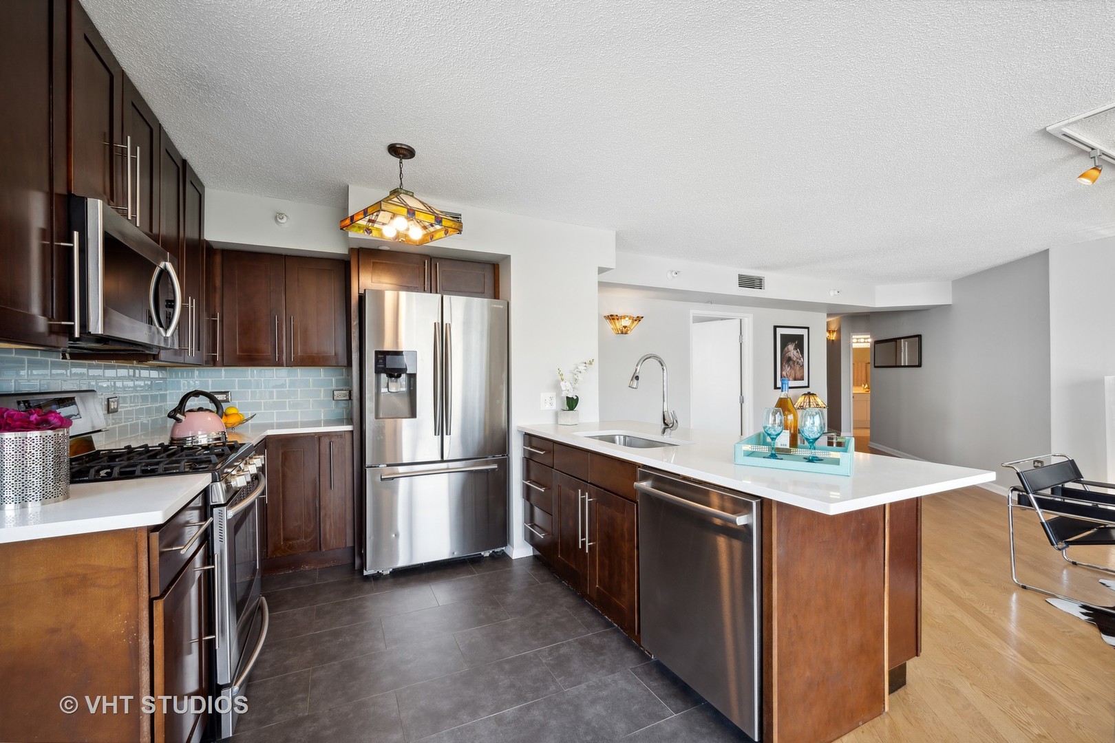 1720 Maple Avenue, Unit 1040 Evanston, IL 60201 - Photo 5 of 35 a kitchen with stainless steel appliances granite countertop a sink dishwasher stove top oven and refrigerator
