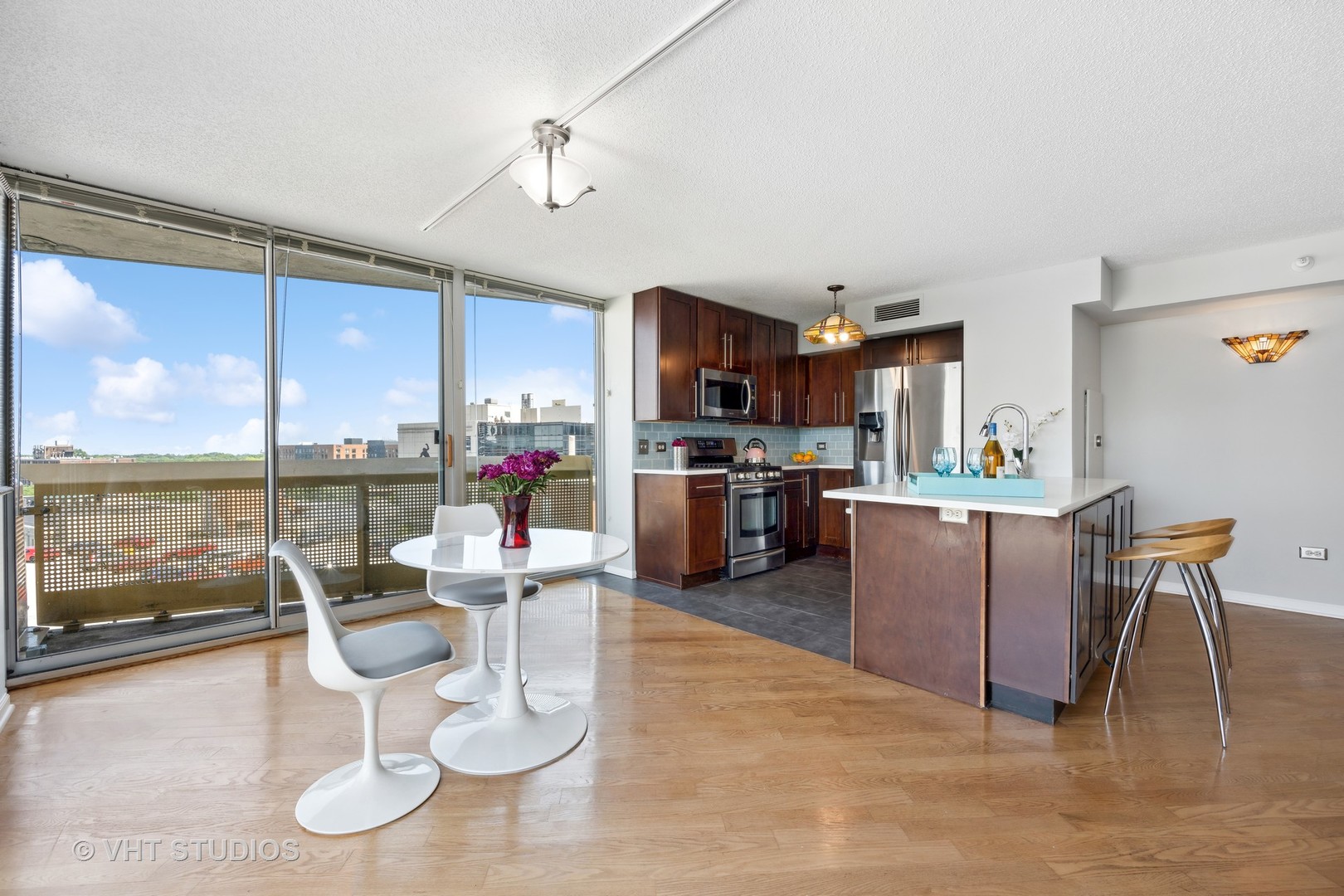 1720 Maple Avenue, Unit 1040 Evanston, IL 60201 - Photo 6 of 35 a kitchen with stainless steel appliances granite countertop a stove top oven a sink and a dining table with garden view