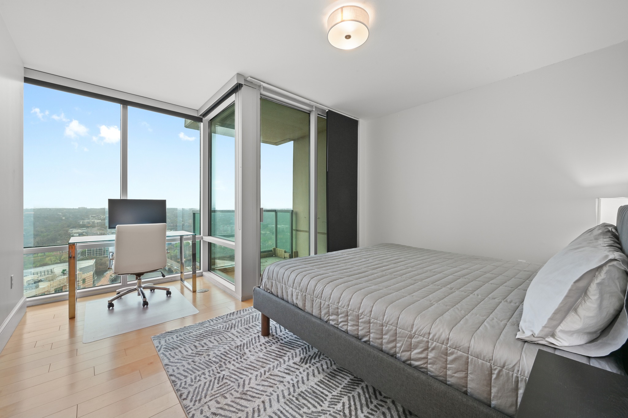 300 Bowie Street, Unit 2902 Austin, TX 78703 - Photo 11 of 40 a bedroom with a bed and large windows