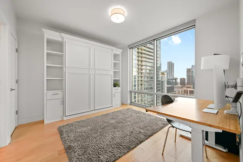 a bedroom with a bed and a large window