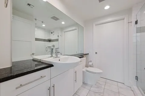a view of bathroom with a sink toilet and a mirror