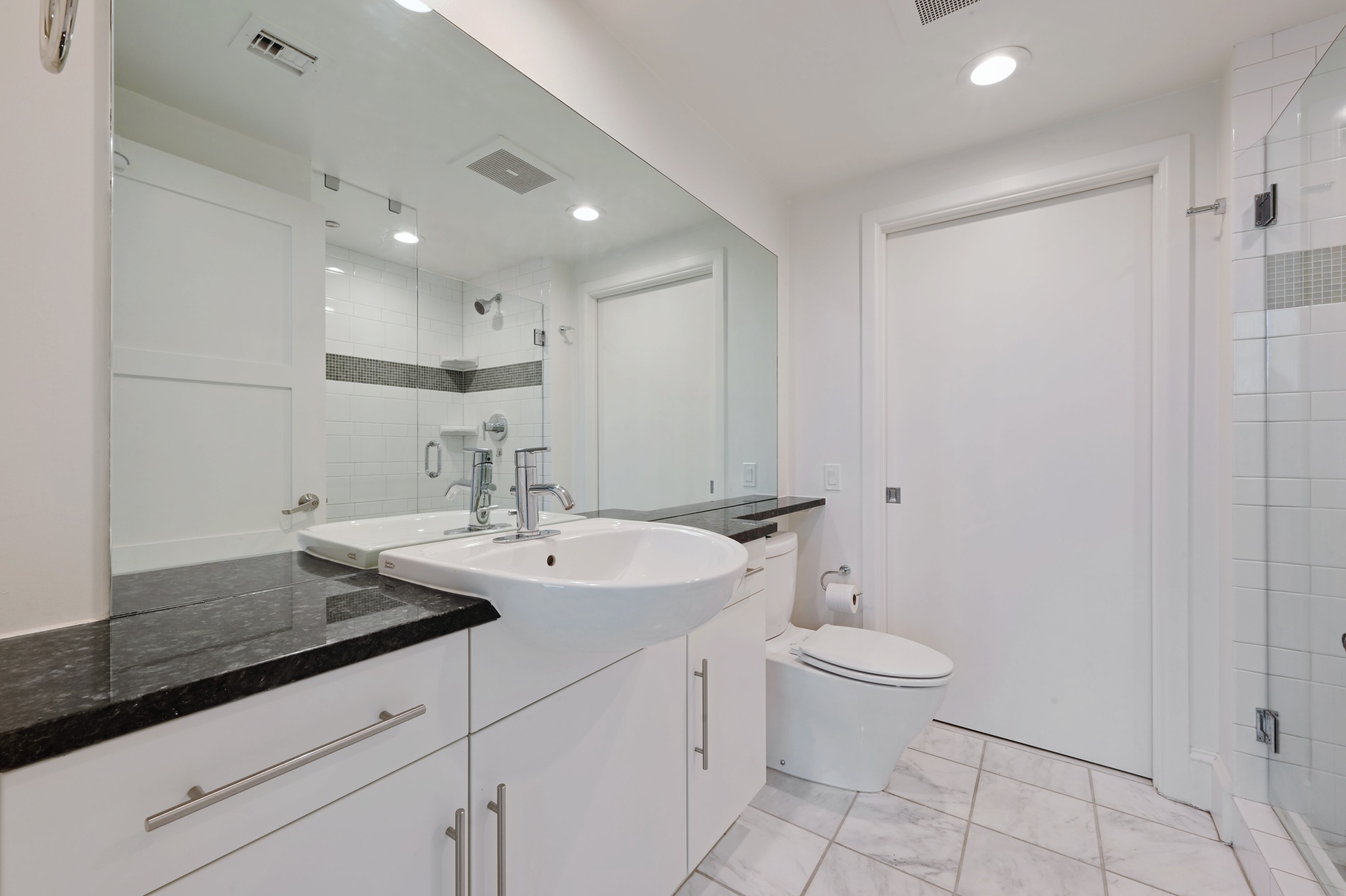 300 Bowie Street, Unit 2902 Austin, TX 78703 - Photo 18 of 40 a view of bathroom with a sink toilet and a mirror