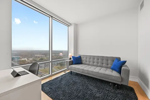 a living room with furniture and a rug