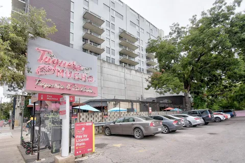 a view of a city with tall buildings and a big yard