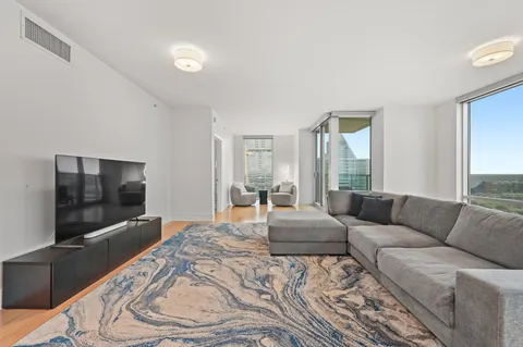 a living room with couches and a flat screen tv