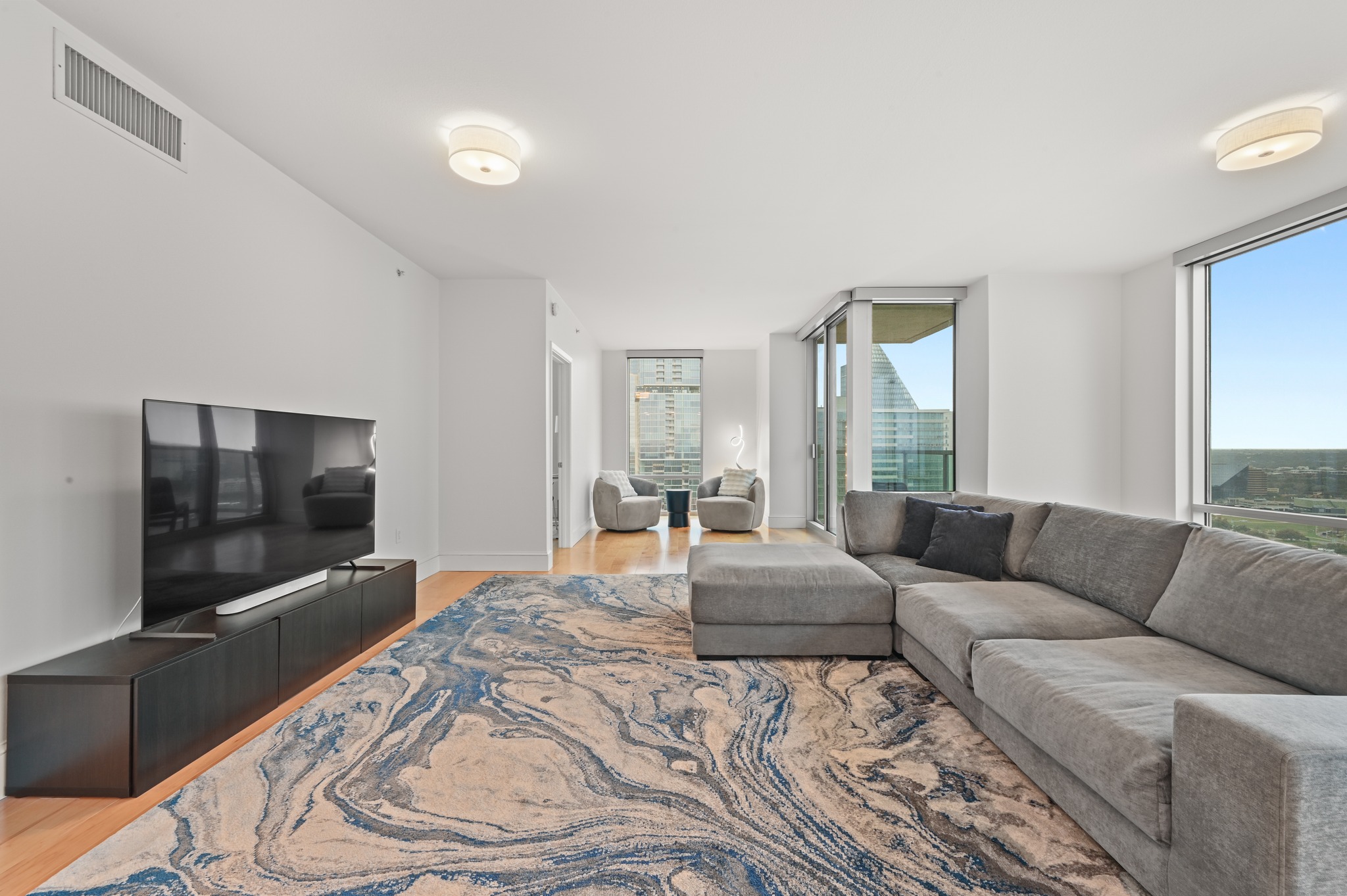 300 Bowie Street, Unit 2902 Austin, TX 78703 - Photo 4 of 40 a living room with couches and a flat screen tv