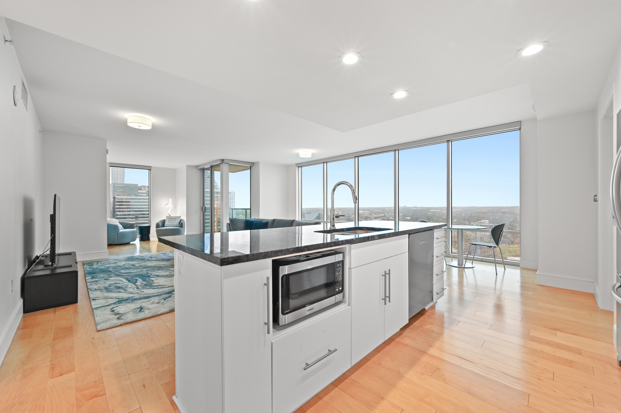300 Bowie Street, Unit 2902 Austin, TX 78703 - Photo 10 of 40 a kitchen with stainless steel appliances granite countertop a stove and white cabinets
