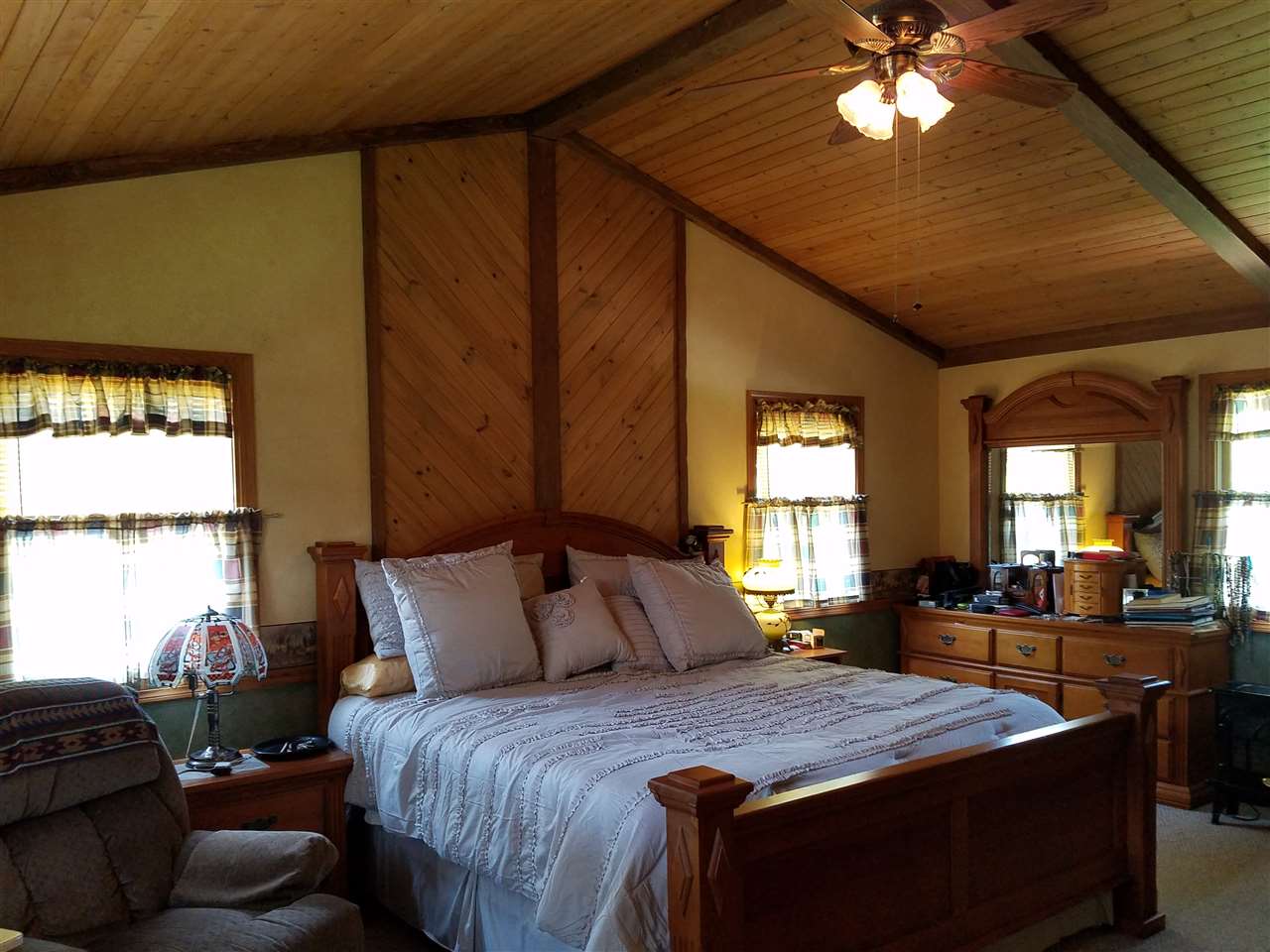 1101 East Spring Creek Road Oregon, IL 61061 - Photo 15 of 22 a bedroom with a large bed and a chandelier