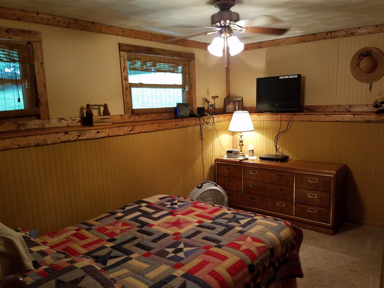 1101 East Spring Creek Road Oregon, IL 61061 - Photo 16 of 22 a bedroom with a bed and a chandelier