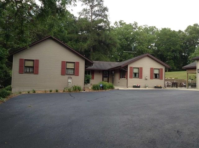 1101 East Spring Creek Road Oregon, IL 61061 - Photo 2 of 22 a view of a house with a yard and garage