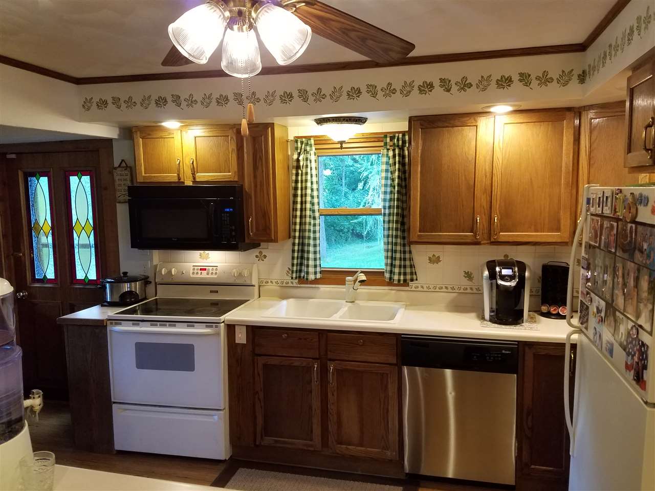 1101 East Spring Creek Road Oregon, IL 61061 - Photo 10 of 22 a kitchen with a sink stove and microwave