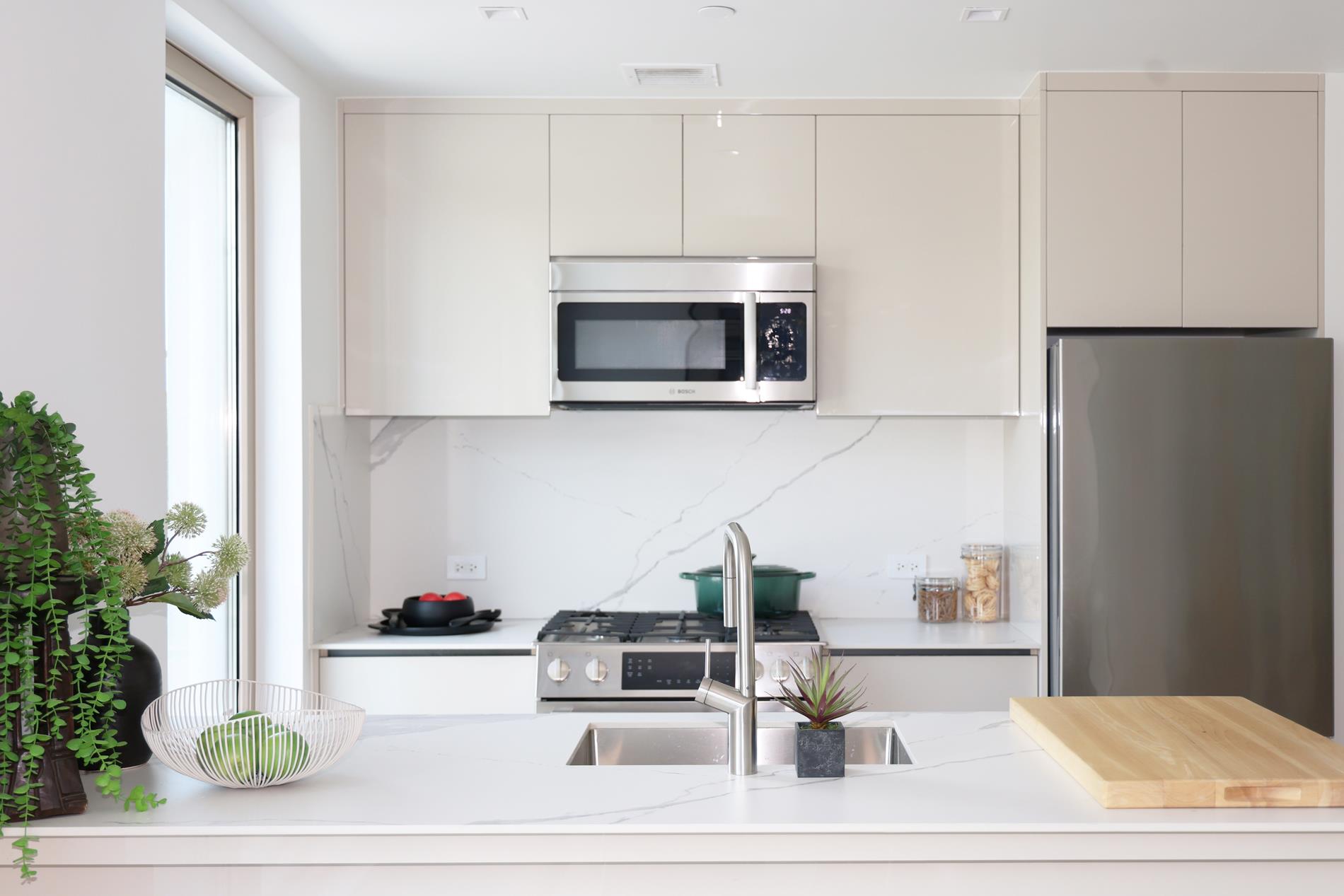 1548 72nd Street, Unit 302 Brooklyn, NY 11228 - Photo 4 of 12 a living room with furniture and a microwave