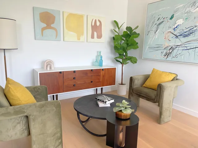 a living room with furniture and a potted plant