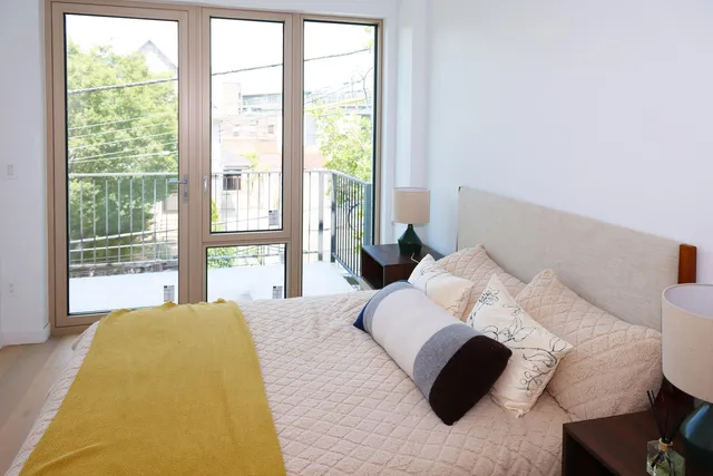 a living room with furniture flowerpot and wooden floor