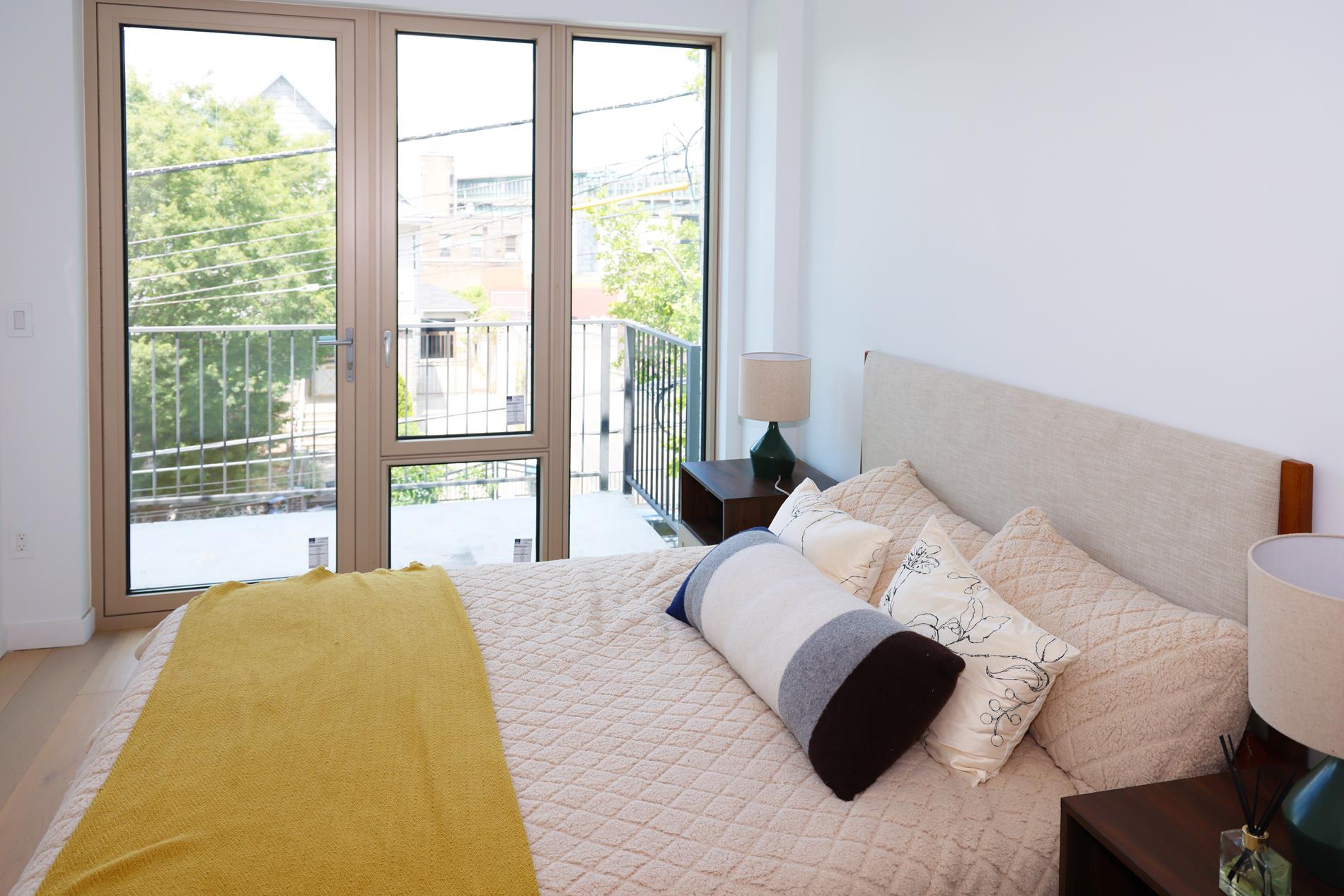 1548 72nd Street, Unit 302 Brooklyn, NY 11228 - Photo 7 of 12 a bedroom with a bed and a large window