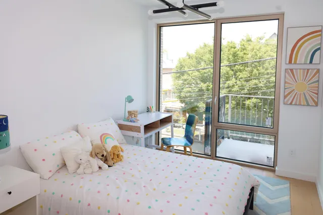 a kitchen with a table chairs white cabinets and wooden floor