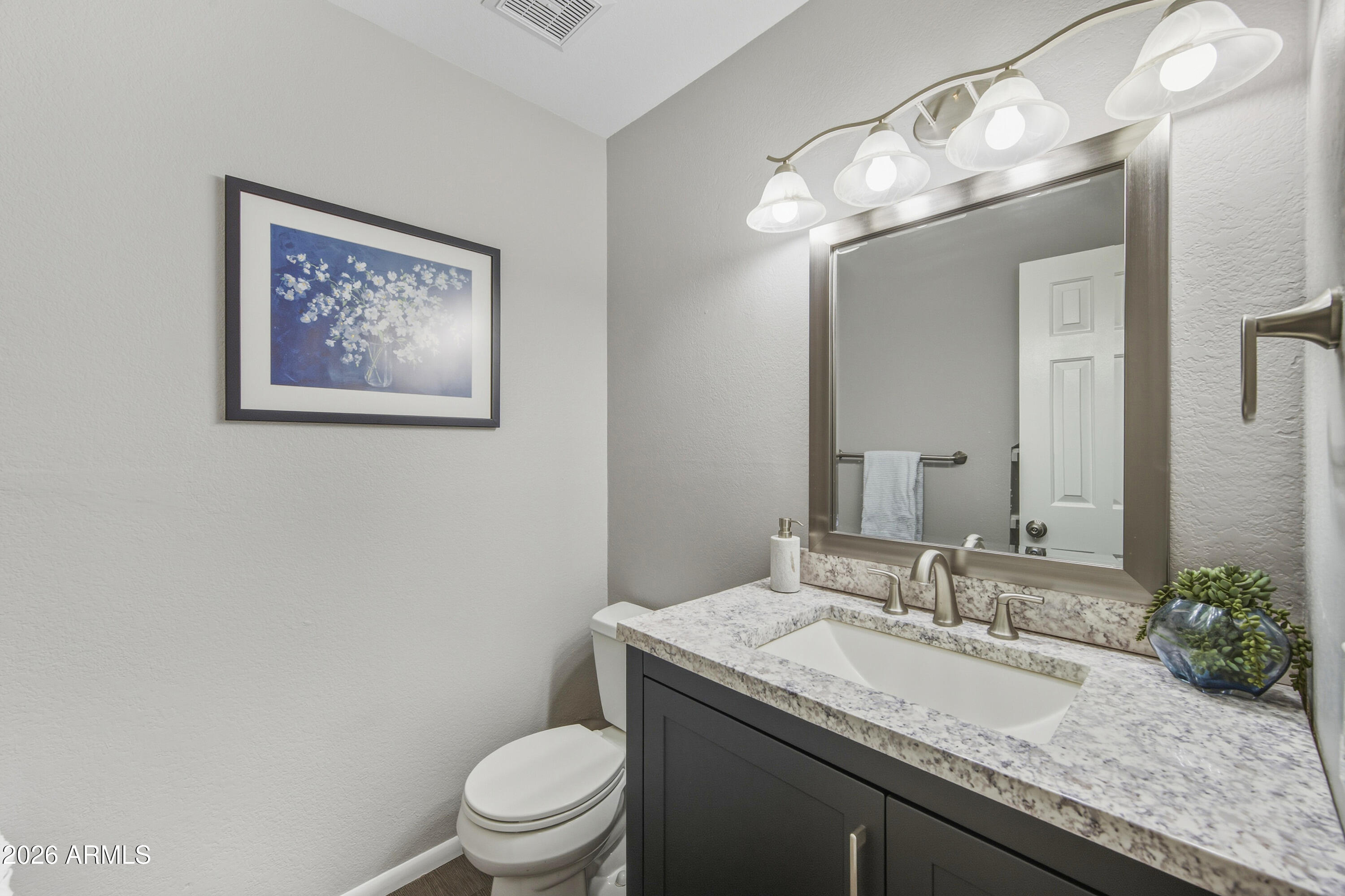 1645 West Baseline Road, Unit 2002 Mesa, AZ 85202 - Photo 12 of 21 a bathroom with a granite countertop sink a toilet and a mirror