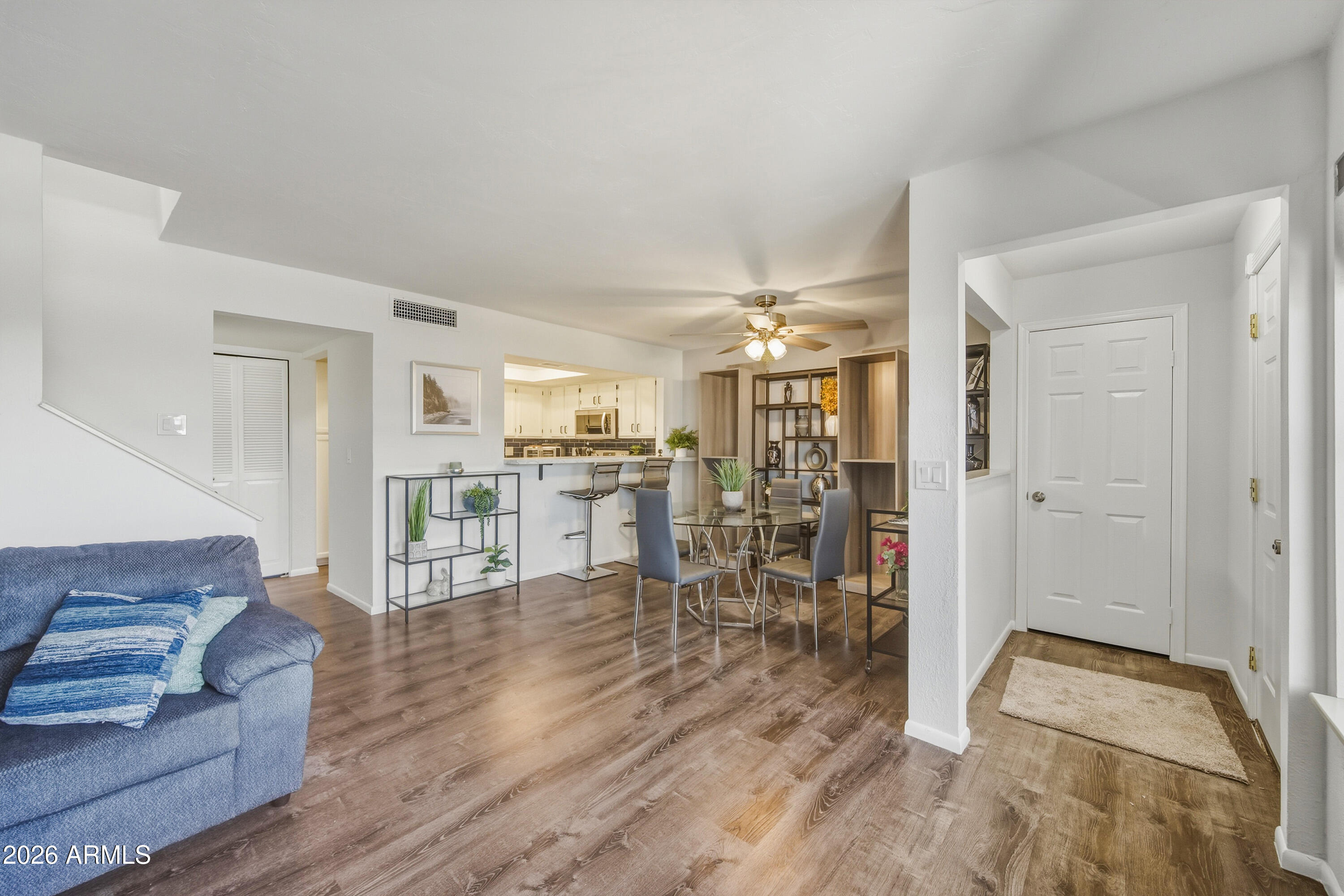 1645 West Baseline Road, Unit 2002 Mesa, AZ 85202 - Photo 4 of 21 a living room with furniture and a dining table with kitchen view