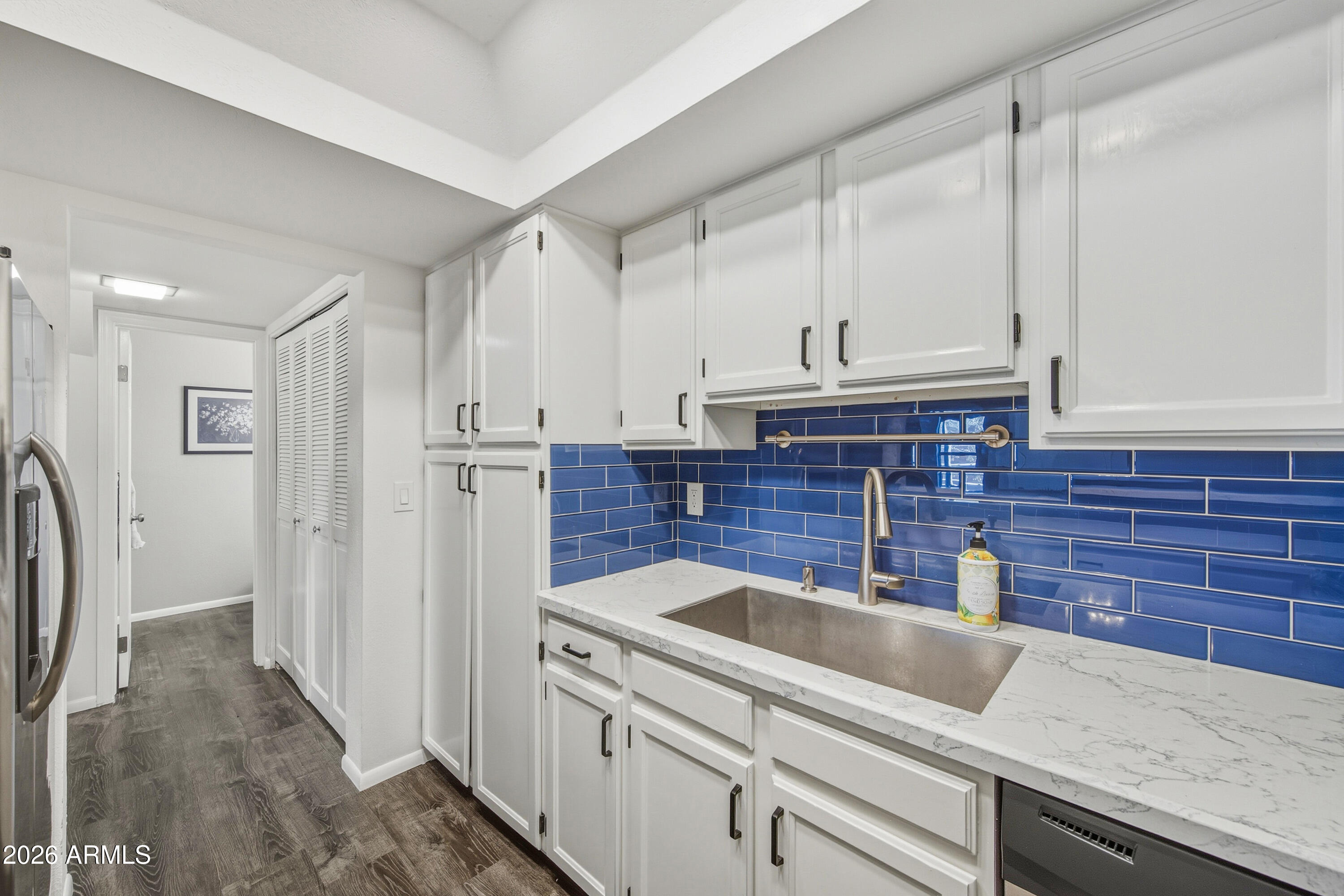 1645 West Baseline Road, Unit 2002 Mesa, AZ 85202 - Photo 7 of 21 a kitchen with stainless steel appliances granite countertop a sink and a refrigerator