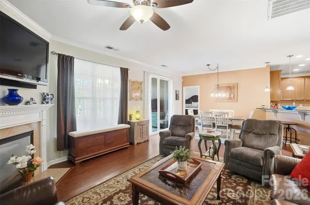 a dining room with furniture and wooden floor