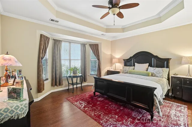 a bedroom with a bed and a large mirror