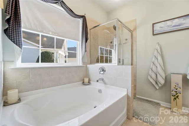 a en suite bathroom with a double vanity sink and a mirror