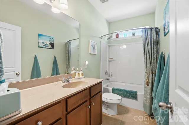 a bathroom with a toilet a sink and a shower