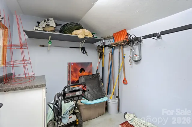 a kitchen with granite countertop white cabinets and a window