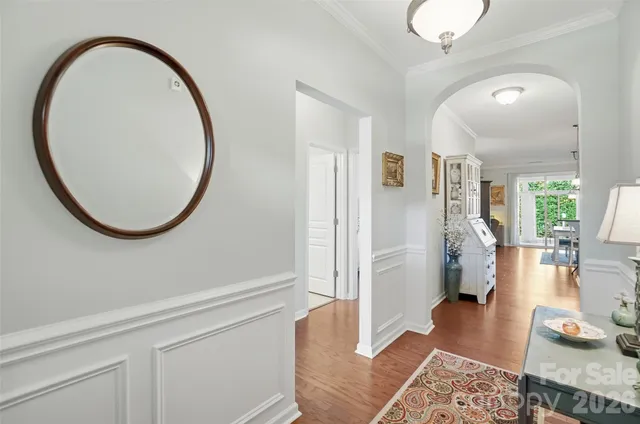 a kitchen with a sink appliances and wooden floor
