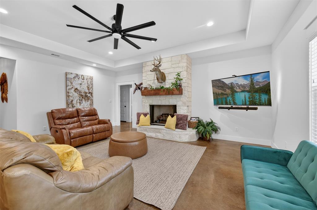 6371 Mill Run Road Athens, TX 75751 - Photo 11 of 40 Living area featuring a stone fireplace with a wooden mantel, a large ceiling fan, and recessed lighting