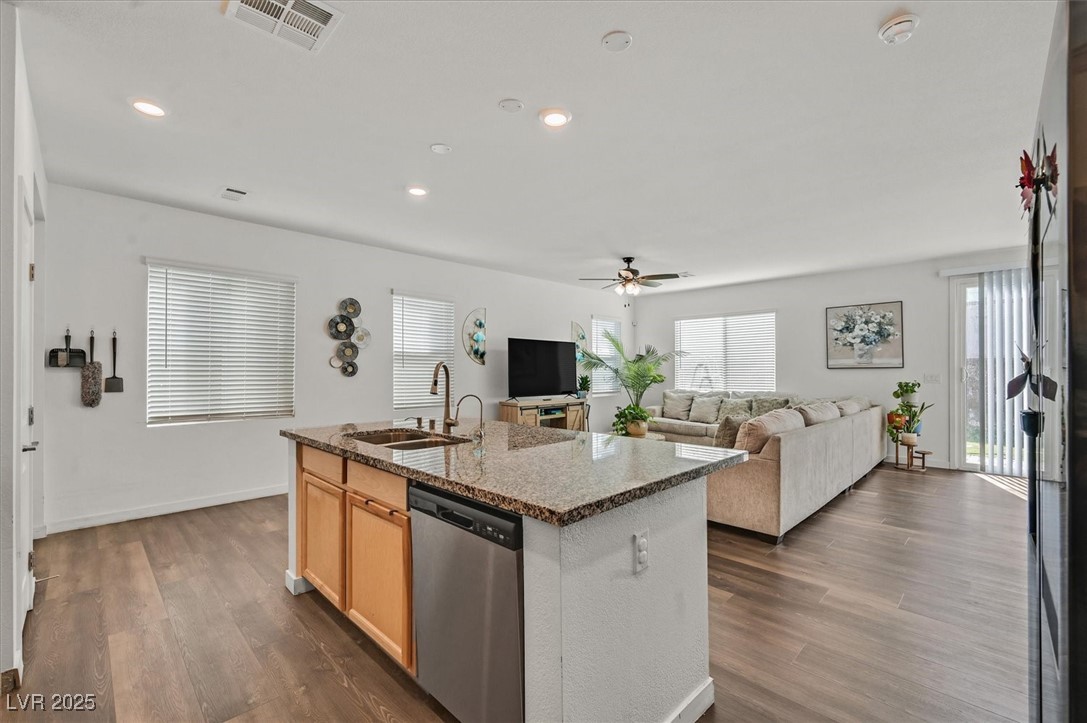 2885 Timber Country Road North Las Vegas, NV 89086 - Photo 11 of 26 Kitchen with a sink, ceiling fan, dark wood-type flooring, visible vents, and stainless steel dishwasher