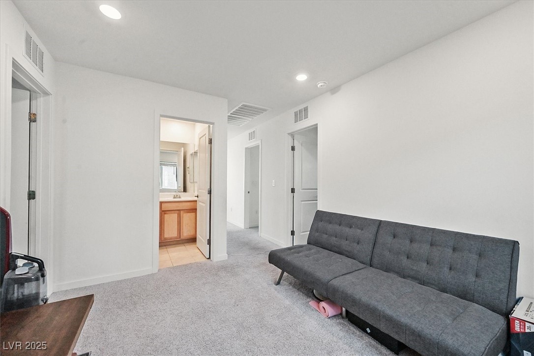 2885 Timber Country Road North Las Vegas, NV 89086 - Photo 14 of 26 Living room with visible vents, light carpet, and recessed lighting