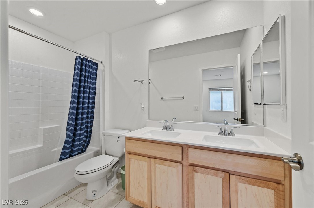 2885 Timber Country Road North Las Vegas, NV 89086 - Photo 15 of 26 Full bath featuring shower / tub combo with curtain, toilet, tile patterned flooring, and a sink
