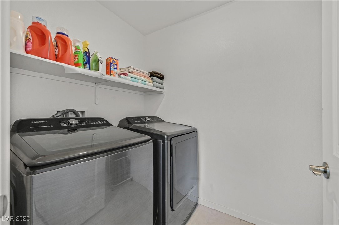2885 Timber Country Road North Las Vegas, NV 89086 - Photo 21 of 26 Laundry area with baseboards, light tile patterned floors, laundry area, and washing machine and dryer