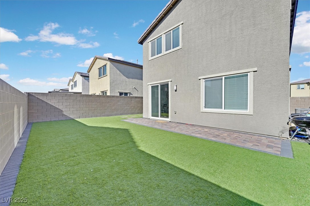 2885 Timber Country Road North Las Vegas, NV 89086 - Photo 25 of 26 Rear view of house with a yard, a fenced backyard, and a patio area