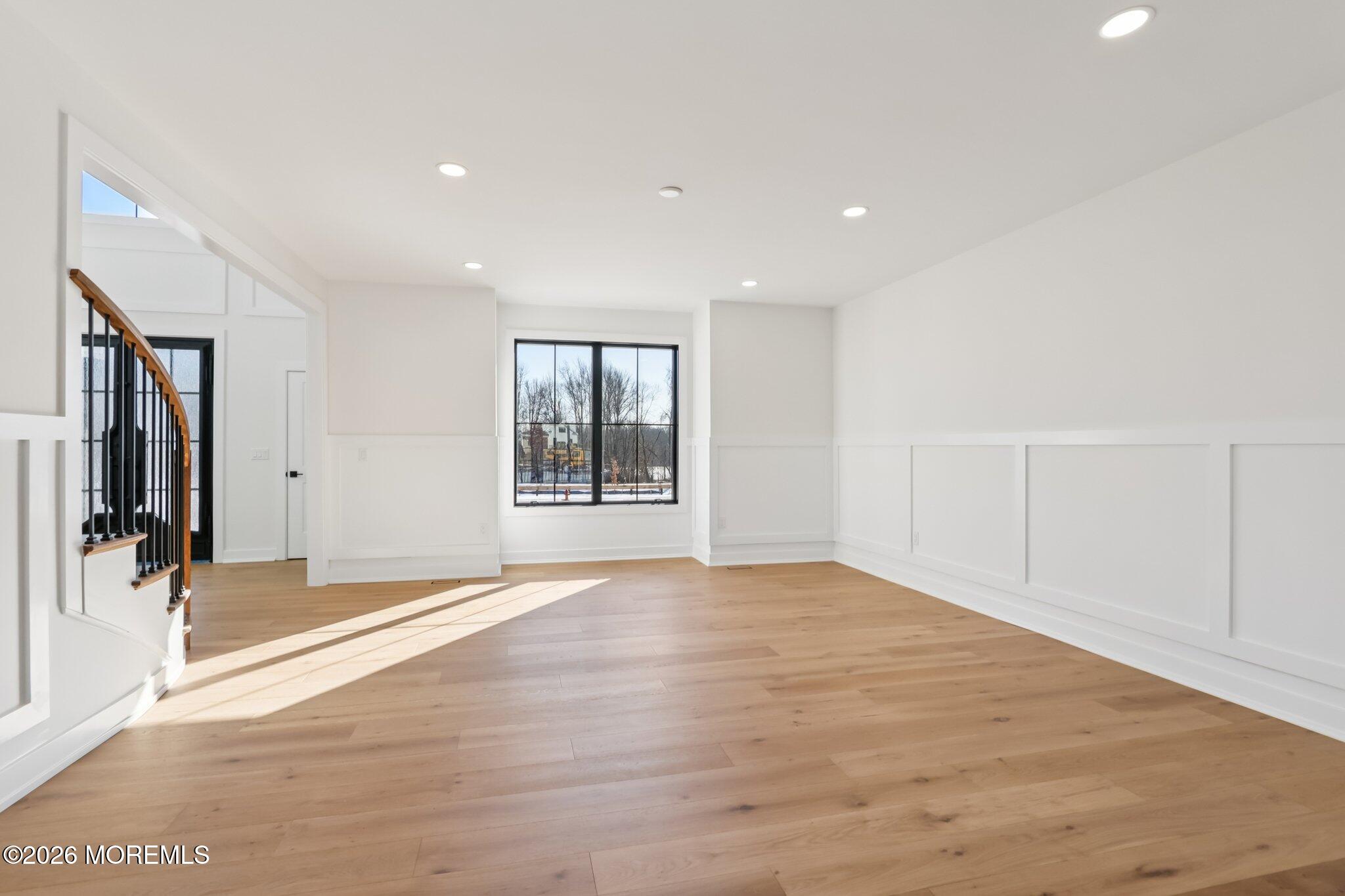 4 Fortune Court Freehold, NJ 07728 - Photo 54 of 104 a view of an empty room with wooden floor and a window