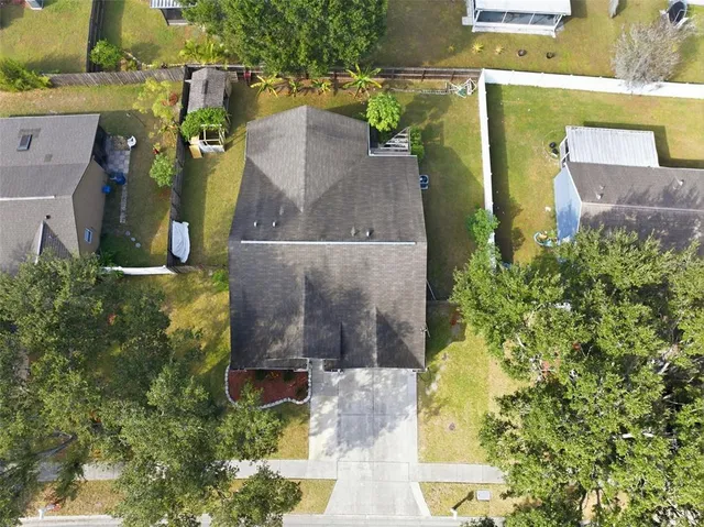 an aerial view of a house with a yard